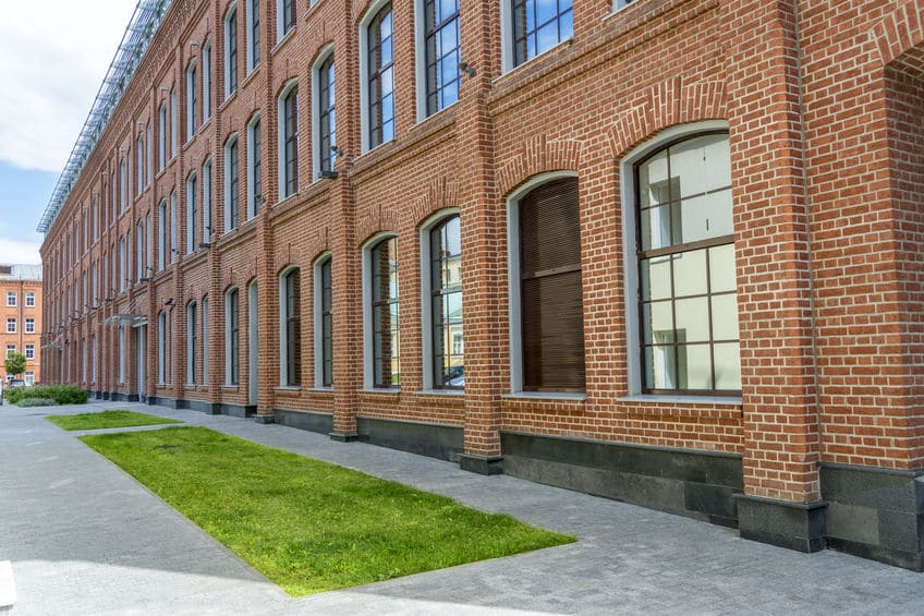 Office building in loft style. Large Windows. Red brick wall.